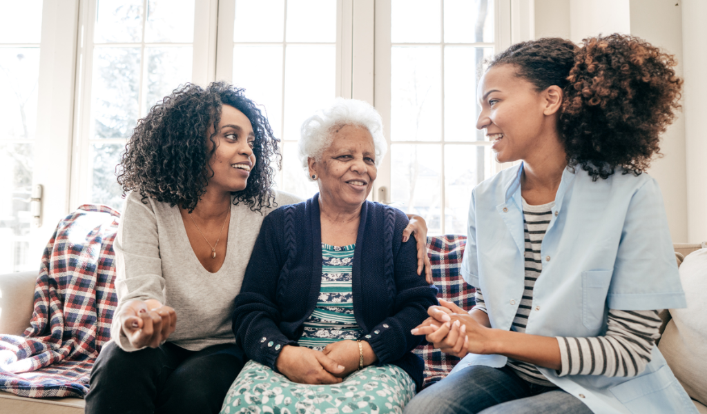 two young women having a conversation with their senior mother