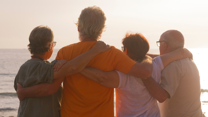 a group of senior friends hugigng each other