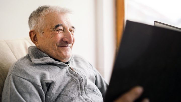 an old men looking through an album