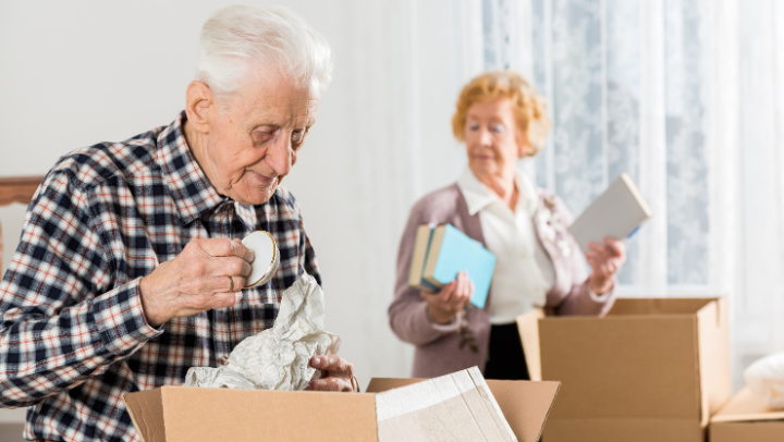 an old couple unpacking boxes