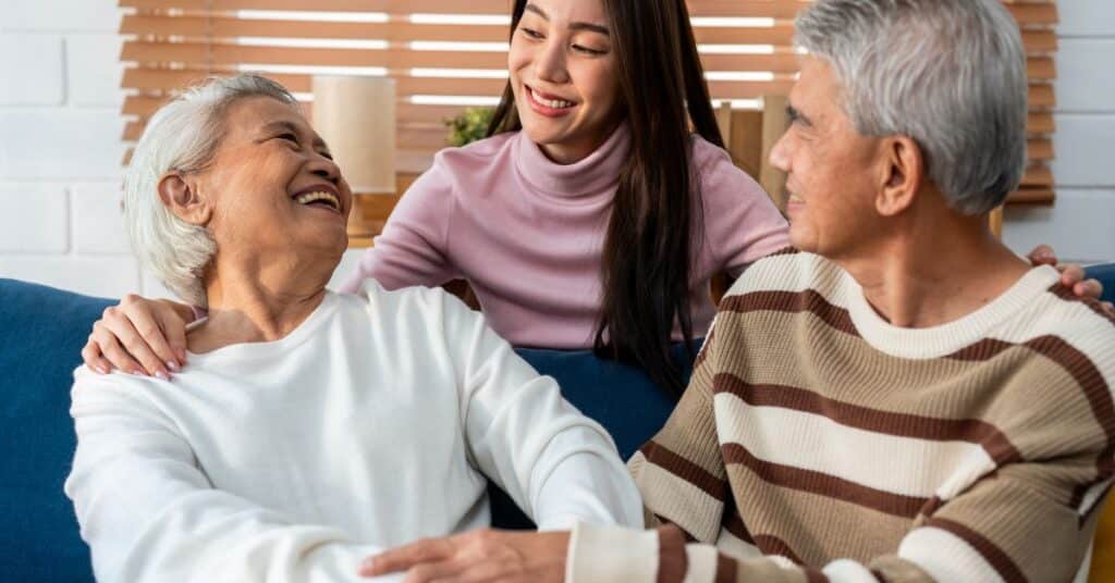 Daughter-Smiling-With-Her-Parents-In-Respite-Care